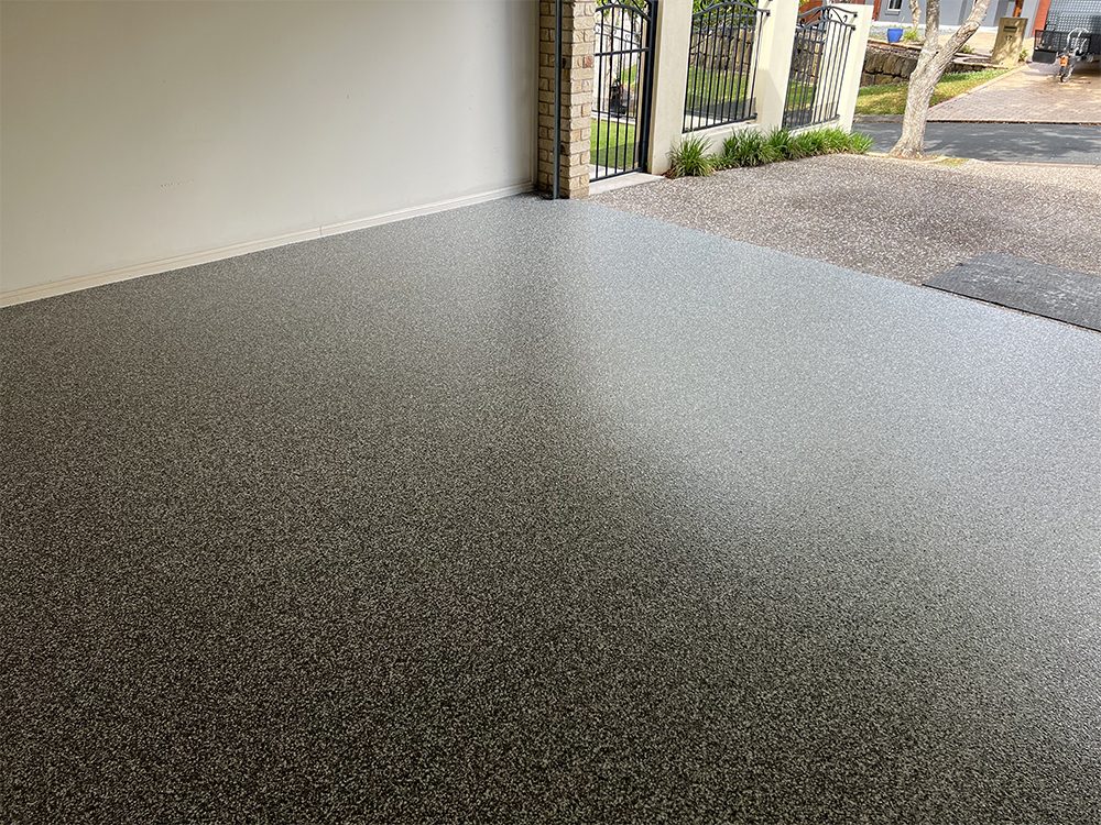 A photo of a new Resin Vinyl epoxy floor taken from the back of a garage to show the beautiful, even finish.