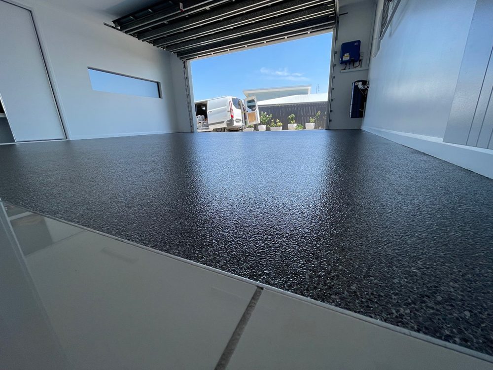 A low-angle photo showing the finish of a Resin Vinyl epoxy flake floor.