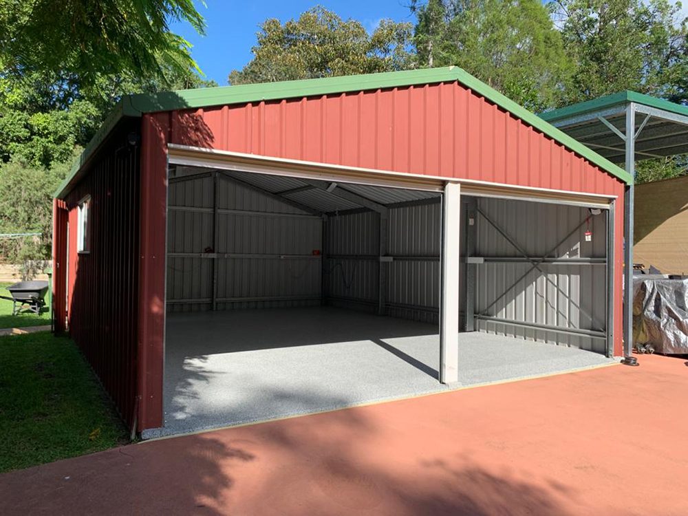 A large multi-purpose garage with the door open showing the new Resin Vinyl epoxy flake floor.